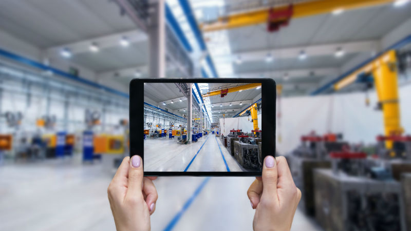 Photo being taken of the inside of a factory on a tablet