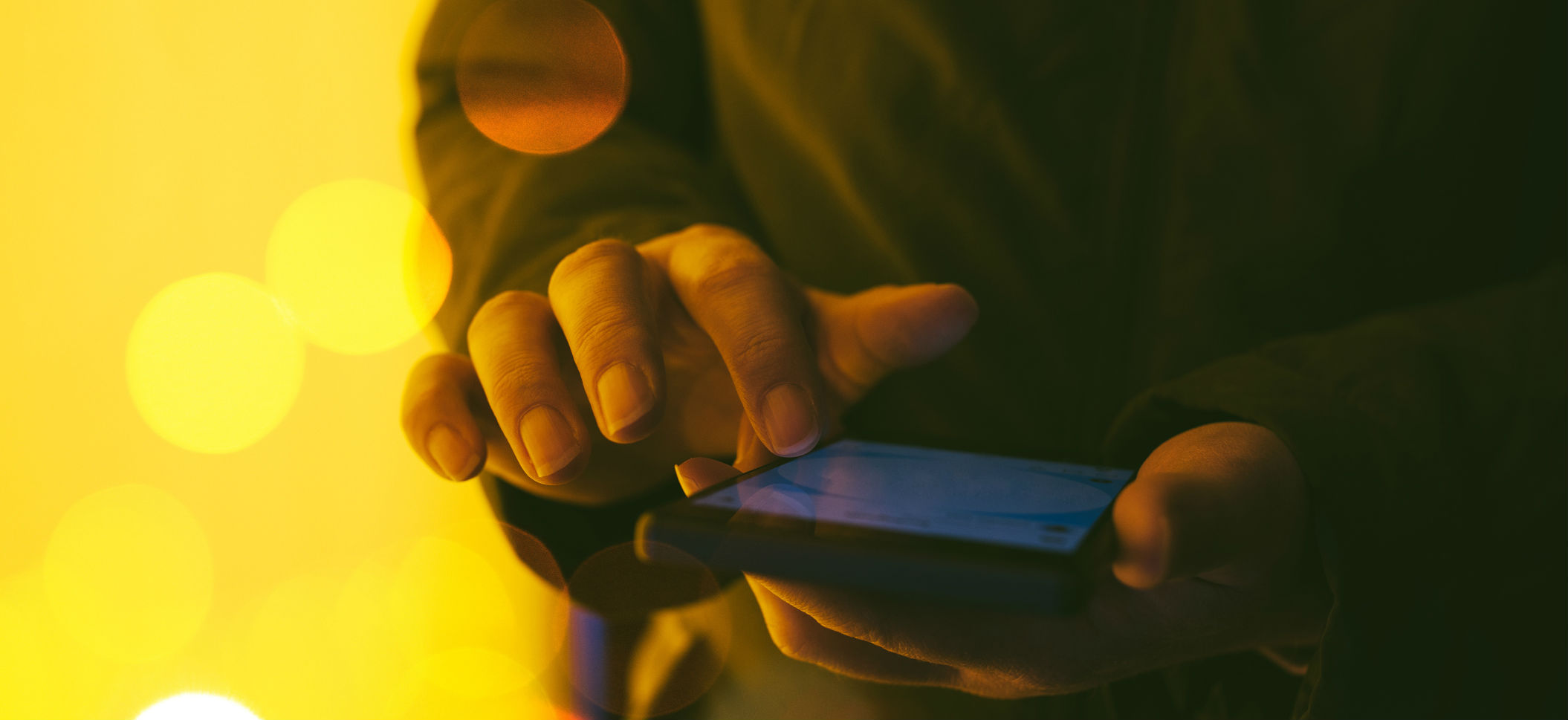 Man playing on phone to reflect cyber insurance in Northumberland and Newcastle