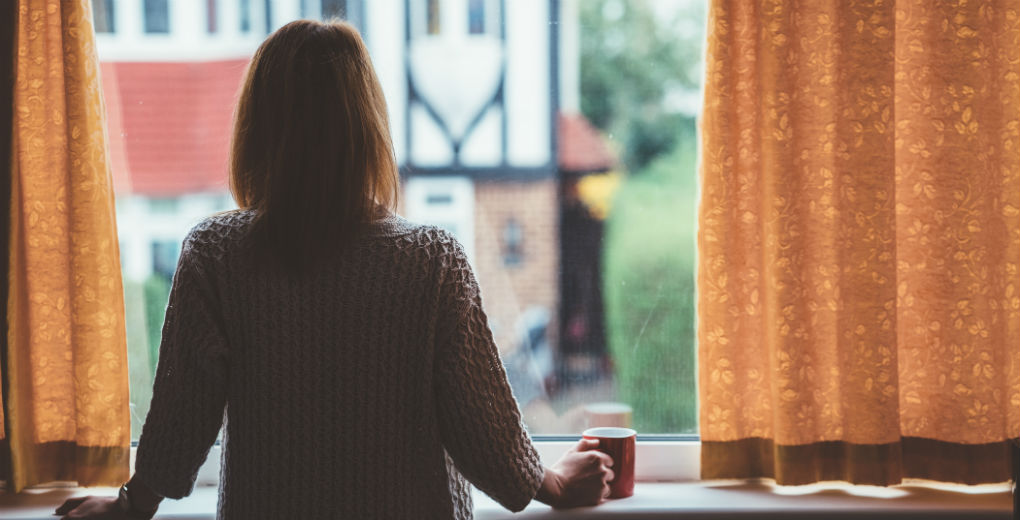 Prisoner's mum looking out of window to reflect convict insurance in Northumberland and Newcastle
